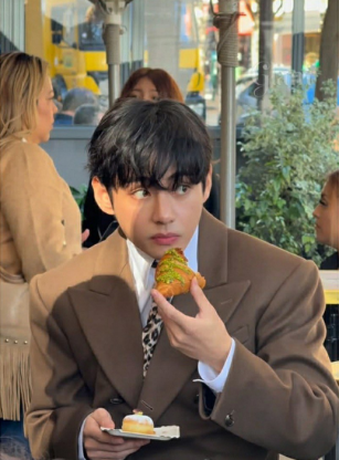 Taehyung eating a croissant